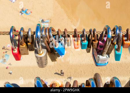 row of padlocks on steel wire fence in albufeira algarve portugal Stock Photo