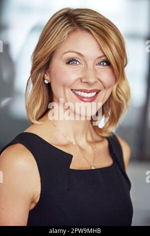 Im on my way to the top. Cropped portrait of a happy businesswoman in the office. Stock Photo
