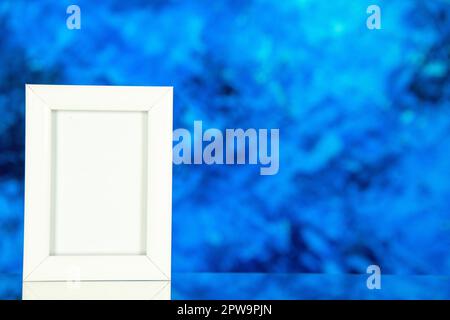 front view white picture frame on blue background color gift present portrait shoot picture family free space Stock Photo