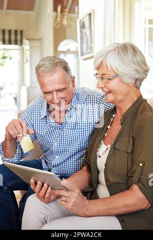 Everything you need is online. a senior couple shopping online on their tablet. Stock Photo