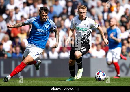 Derby County's Louie Sibley (right) and Portsmouth's Marlon Pack battle for the ball during the Sky Bet League One match at Pride Park, Derby. Picture date: Saturday April 29, 2023. Stock Photo