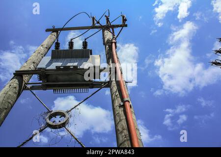 Bottom view of Telephone pole in Hong Kong with blue sky. Illustration on the theme of telephone service supply. Rural scene. Stock Photo