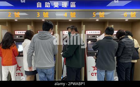 People apply for Home Return Permit at Hong Kong Island Service Centre of China Travel Service Hong Kong Ltd (CTS) in Sheung Wan. 29DEC22   SCMP / Jelly Tse Stock Photo