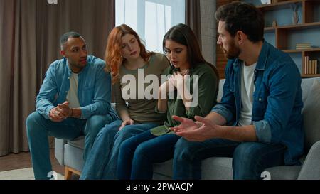 Sad crying woman sharing life problem grief with friends multiracial women men consoling hug upset girl provide psychological help care support Stock Photo
