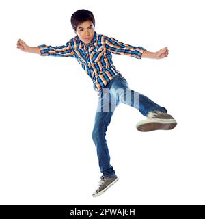 Time to spring into action. Studio shot of a young boy jumping energetically against a white background. Stock Photo
