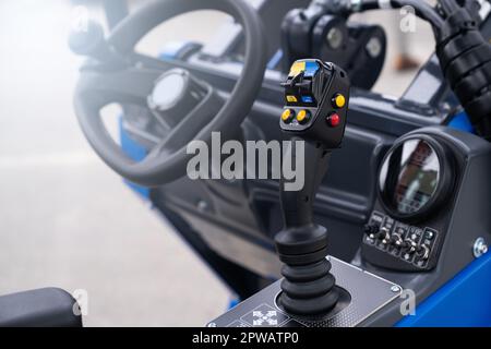 Steering wheel and joystick to drive a tractor. High quality photo Stock Photo