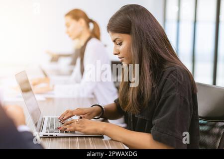 India business woman employee woking in office typing data in laptop computer Stock Photo