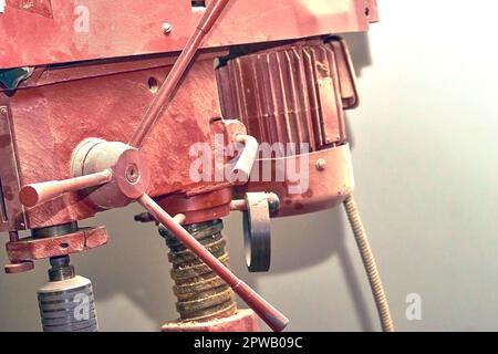 Red ginger professional drilling machine isolated on white background. Stock Photo
