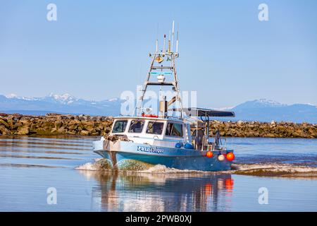 Fish boat returning to Steveston Harbour in British Columbia Canada Stock Photo