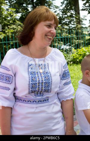 happy woman laughing in a dress embroidered in nature Stock Photo