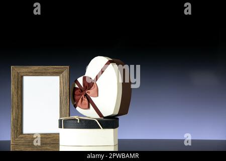 front view valentines day presents with picture frame on the dark background passion marriage couple love heart color feeling Stock Photo