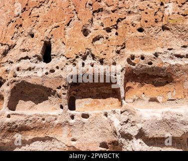 Caves from and ancient civilisation are carved into the side of a cliff at Bandelier National Monument near Santa Fe, New Mexico. Stock Photo