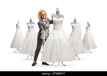 Seamstress measuring a bridal gown on a mannequin doll isolated on white background Stock Photo