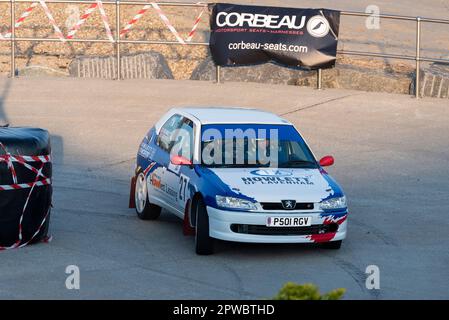 Ben Howlett racing a Peugeot 306 competing in the Corbeau Seats rally on the seafront at Clacton, Essex, UK. Co driver Simon Howlett Stock Photo