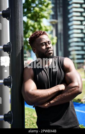 Confident fit sporty young black man standing outdoors. Stock Photo