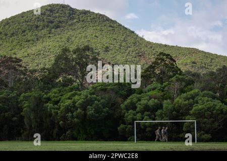 U.S. Army Soldiers with 100th Battalion, 442nd Infantry Regiment arrive to the base soccer pitch to execute medical evacuation training drills during Exercise Croix du Sud at Plum, New Caledonia, April 27, 2023. During Croix du Sud, participants from 14 countries including service members from U.S. Army Pacific, the U.S. Marine Corps, U.S. Navy and the U.S. Air Force join Allied and partner nations in enhancing combined interoperability through training, skills sharing, and cultural exchanges. Marines and Sailors with Combat Logistics Battalion 5 are supporting the Joint Operations Center with Stock Photo