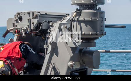 230425-N-DQ787-101036  ATLANTIC OCEAN (April 25, 2023) Gunner’s Mate 3rd Class Zackary Lehman performs preventive maintenance on the MK 38 25mm machine gun aboard the amphibious assault ship USS Wasp (LHD 1), April 25, 2023. Wasp is underway conducting Basic Phase inspections and assessments. (U.S. Navy photo by Mass Communication Specialist 2nd Class David Glotzbach) Stock Photo