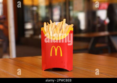 MYKOLAIV, UKRAINE - AUGUST 11, 2021: Big portion of McDonald's French fries on table in cafe Stock Photo