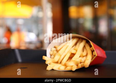 MYKOLAIV, UKRAINE - AUGUST 11, 2021: Big portion of McDonald's French fries on tray in cafe. Space for text Stock Photo