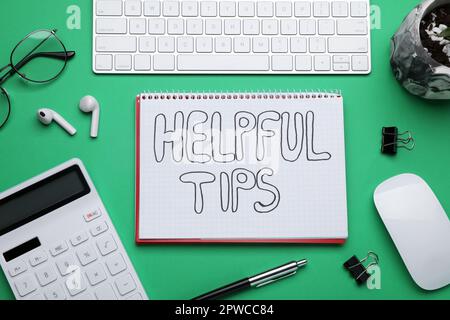 Helpful Tips. Flat lay composition with notebook, calculator and computer keyboard on green background Stock Photo