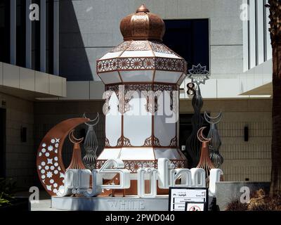 Cairo, Egypt, April 24 2023: festive decorations of Islamic Ramadan fasting month in Egyptian streets at daylight of stars, crescent moon, mosque mina Stock Photo