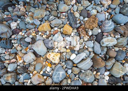 amazing to see on the beach is full of round rocks instead of sand.  round rocks have beautiful color and various size.  rocks beach at the lighthouse Stock Photo