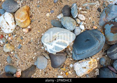 amazing to see on the beach is full of round rocks instead of sand.  round rocks have beautiful color and various size.  rocks beach at the lighthouse Stock Photo