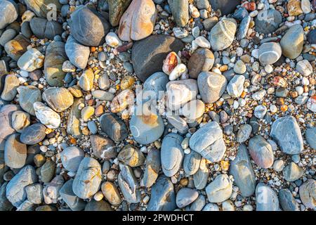 amazing to see on the beach is full of round rocks instead of sand.  round rocks have beautiful color and various size.  rocks beach at the lighthouse Stock Photo