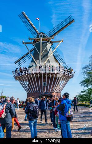 LISSE, HOLLAND - APRIL 19, 2023: Visitors enjoy sunny day in Keukenhof Park, one of the world's largest flower gardens popular with tourists Stock Photo