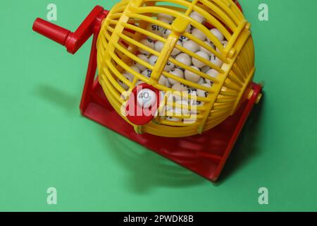 Random number dispenser to help with choosing Lottery, Lotto or just plain Bingo numbers, on a  simple green background with copy space Stock Photo