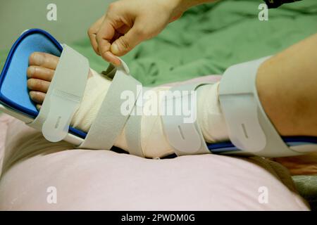 Concept of bandaging and treating an ankle injury at home Stock Photo
