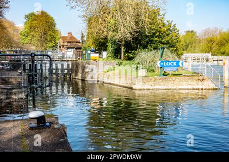 Caversham Lock and weir on The River Thames at Reading in Berkshire, UK with a blue sign directing boats to the lock. Stock Photo