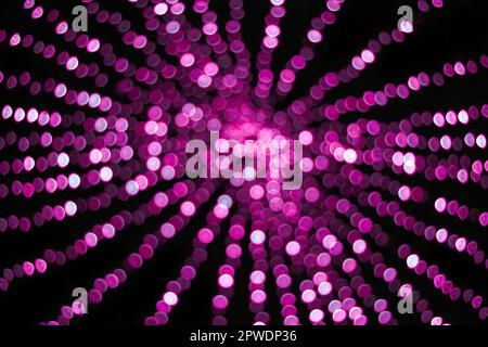 abstract pink-purple color Christmas lights, bokeh balls, and light bokeh out-of-focus lights texture on black background Stock Photo