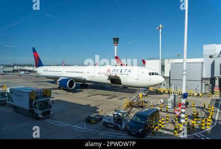 London, United Kingdom - 04-07-2023: Delta Airlines Parked At Heathrow Airport Being Loaded For Flight Stock Photo