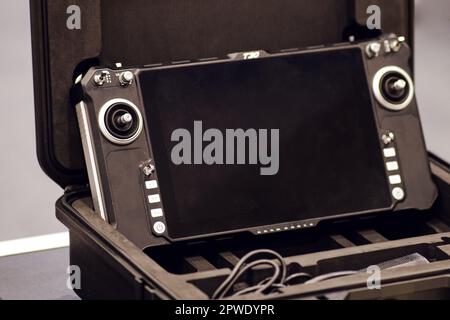 Using remote control to operate a drone with a video camera for the purpose of detecting and eliminating enemy positions in military operations. Stock Photo