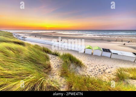 Beach houses on Westkapelle beach seen from the dunes in Zeeland at sunset, Netherlands. Landscape scene of nature in Europe. Stock Photo