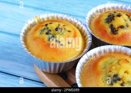 Closeup of Mouthwatering Freshly Baked Passion Fruit Muffins in Molds Stock Photo