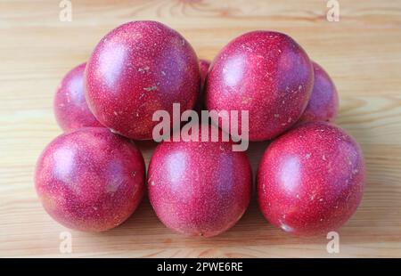Pile of Fresh Ripe Passion Fruits on Wooden Table Stock Photo