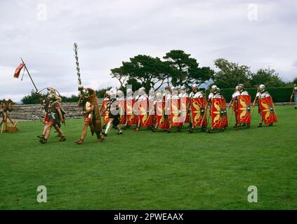 Ermine Street Guard display at Segontium Roman Fort, Caernarfon. Standard Bearers and Cornicen, preceeding Centurion, followd by Legionaries Stock Photo