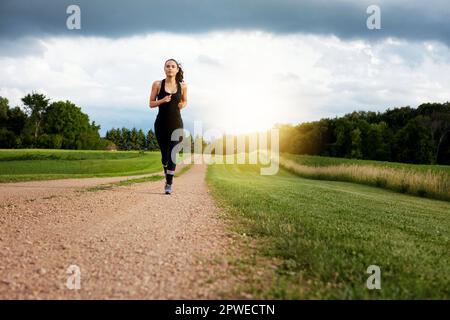 This princess wears running shoes. a fit young woman out for a run on a beautiful day. Stock Photo