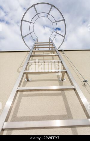 View from below of the technical ladder leading to the building's roof. Stock Photo
