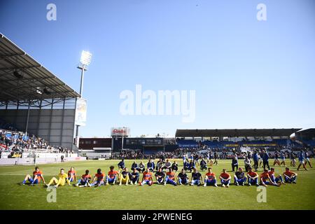 30 April 2023, Schleswig-Holstein, Kiel: Soccer: 2nd Bundesliga, Holstein Kiel - Darmstadt 98, Matchday 30, Holstein Stadium. The Darmstadt players sit in front of the visitors' stand after their 0:3 win and let themselves be celebrated. Photo: Gregor Fischer/dpa - IMPORTANT NOTE: In accordance with the requirements of the DFL Deutsche Fußball Liga and the DFB Deutscher Fußball-Bund, it is prohibited to use or have used photographs taken in the stadium and/or of the match in the form of sequence pictures and/or video-like photo series. Stock Photo