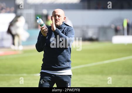 30 April 2023, Schleswig-Holstein, Kiel: Soccer: 2nd Bundesliga, Holstein Kiel - Darmstadt 98, Matchday 30, Holstein Stadium. Darmstadt's coach Torsten Lieberknecht joins the fans after the 0:3 win and applauds. Photo: Gregor Fischer/dpa - IMPORTANT NOTE: In accordance with the requirements of the DFL Deutsche Fußball Liga and the DFB Deutscher Fußball-Bund, it is prohibited to use or have used photographs taken in the stadium and/or of the match in the form of sequence pictures and/or video-like photo series. Stock Photo