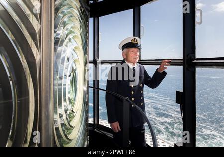 Galley Head, Cork, Ireland. 30th April, 2023. Attendant light keeper Gerald Butler looks out to sea from the top of the lighthouse during an open day organised by the Galley Flash Rowing Club at Galley Head, Co. Cork, Ireland.  - Credit; David Creedon / Alamy Live News Stock Photo