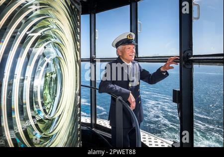 Galley Head, Cork, Ireland. 30th April, 2023. Attendant light keeper Gerald Butler looks out to sea from the top of the lighthouse during an open day organised by the Galley Flash Rowing Club at Galley Head, Co. Cork, Ireland.  - Credit; David Creedon / Alamy Live News Stock Photo