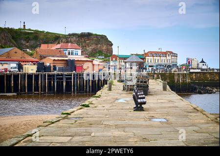 Lobster pots stacked on stone jetty on Whitby harbour Stock Photo