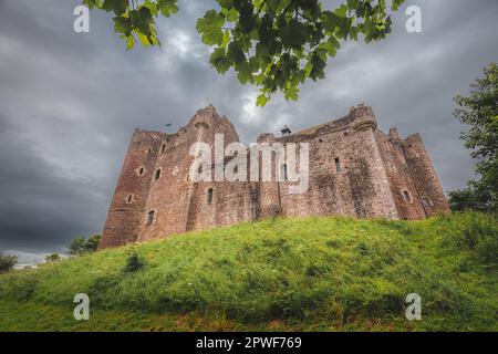 Historic 14th century medieval Doune Castle, with a dark, moody, dramatic sky in Perthshire, Scotland. Stock Photo