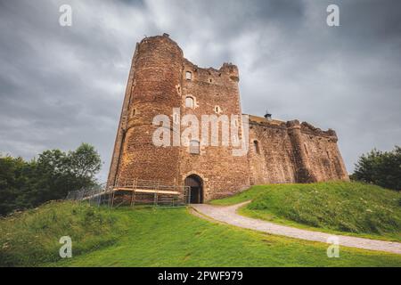 Historic 14th century medieval Doune Castle, with a dark, moody, dramatic sky in Perthshire, Scotland. Stock Photo