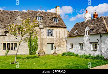 Jenner Hall sundial and cottage on Cricklade church green Wiltshire UK Stock Photo