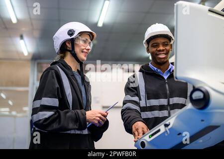 Technician engineer team checking and repairing part of automatic machine Stock Photo